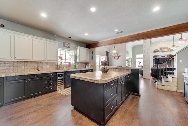 3408 Fm 2280, Cleburne, TX 76031 - kitchen with wine cooler, white cabinets, dark wood finished floors, recessed lighting, and tasteful backsplash