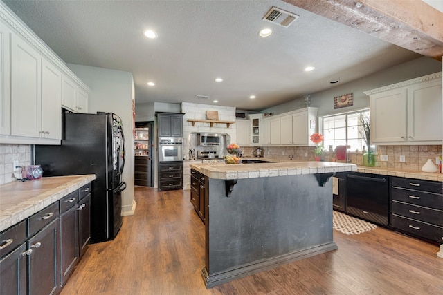 3408 Fm 2280, Cleburne, TX 76031 - kitchen with black appliances, white cabinets, decorative backsplash, and recessed lighting