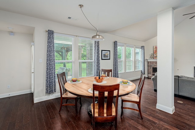 4409 Switchgrass St, Celina, TX 75009 - dining space with vaulted ceiling, baseboards, visible vents, wood finished floors, and a fireplace