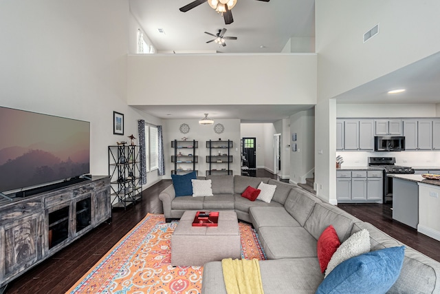4409 Switchgrass St, Celina, TX 75009 - living area featuring a ceiling fan, a towering ceiling, dark wood-type flooring, and visible vents