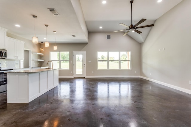 kitchen featuring appliances with stainless steel finishes, a sink, recessed lighting, finished concrete floors, and visible vents