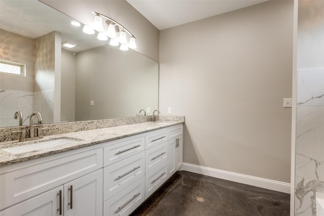 full bath with a sink, baseboards, concrete flooring, and double vanity