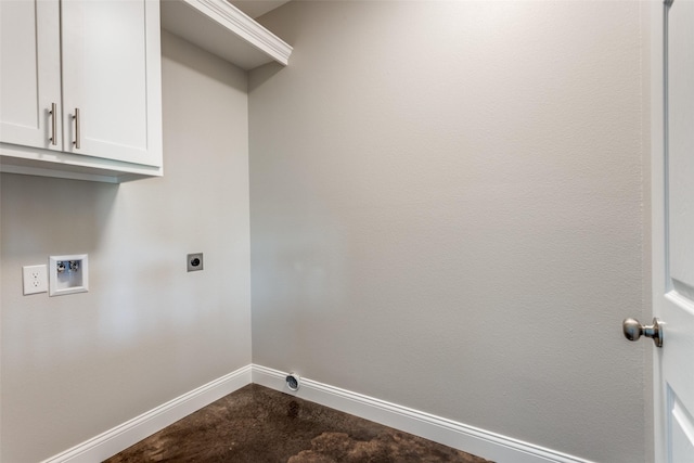 washroom with baseboards, hookup for an electric dryer, washer hookup, and cabinet space