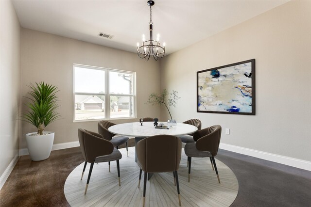 dining room with visible vents, baseboards, and a notable chandelier