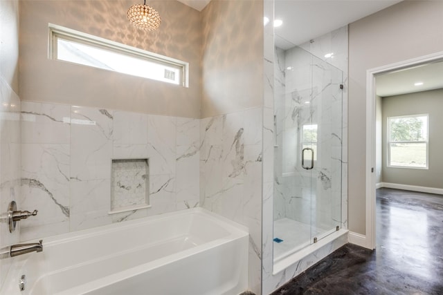 full bath featuring baseboards, an inviting chandelier, a shower stall, and a tub to relax in