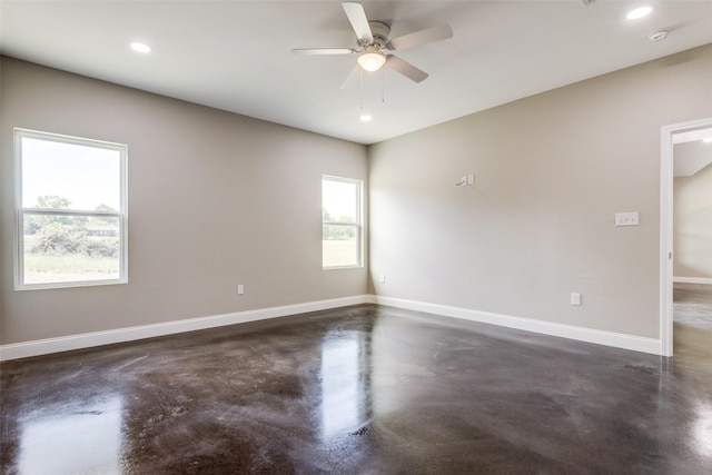 spare room featuring baseboards, a ceiling fan, concrete flooring, and recessed lighting