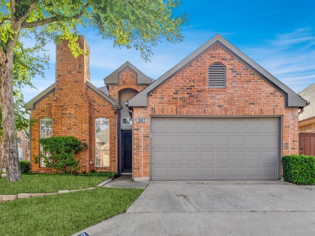 traditional home featuring a chimney, a front yard, a garage, brick siding, and concrete driveway