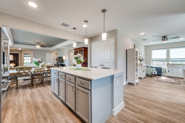 1232 Bright Stars Dr, Little Elm, TX 76227 - kitchen featuring ceiling fan, gray cabinetry, open floor plan, and visible vents
