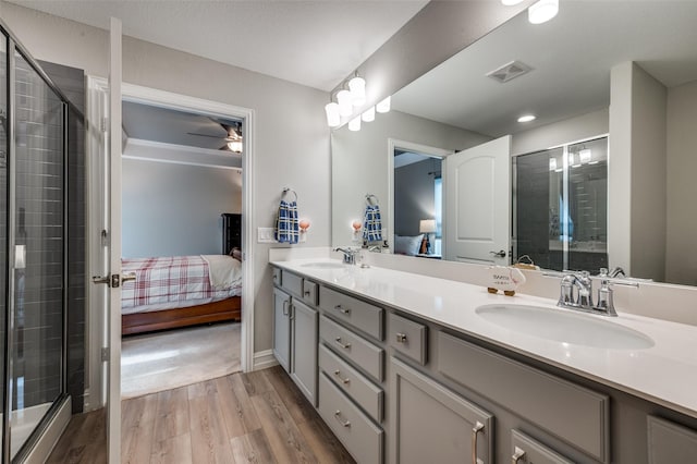 1232 Bright Stars Dr, Little Elm, TX 76227 - ensuite bathroom featuring a sink, connected bathroom, visible vents, and wood finished floors