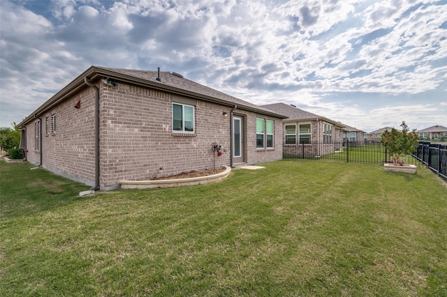 1232 Bright Stars Dr, Little Elm, TX 76227 - back of house with a yard, a shingled roof, brick siding, and a fenced backyard