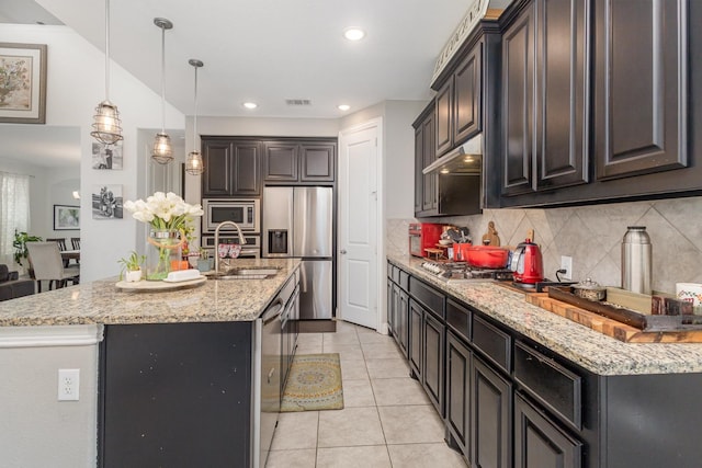 kitchen with backsplash, visible vents, appliances with stainless steel finishes, a sink, and light tile patterned flooring