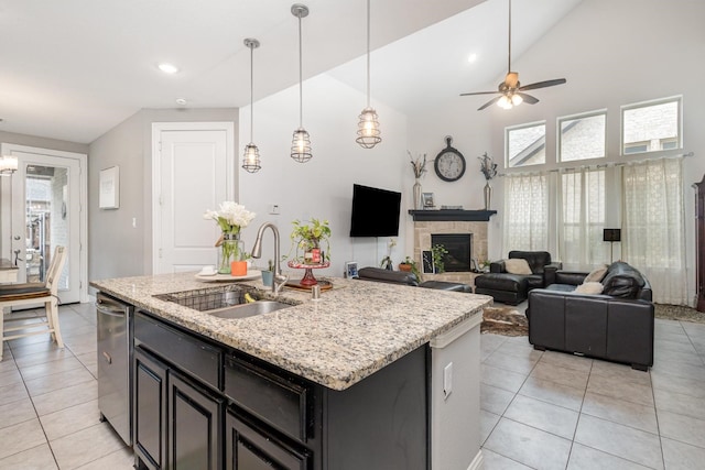 kitchen featuring a sink, light tile patterned floors, and vaulted ceiling