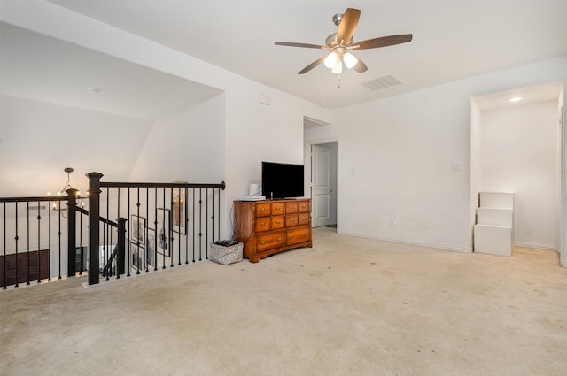 interior space featuring carpet floors, ceiling fan, baseboards, and visible vents