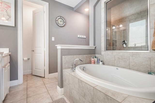 bathroom featuring a garden tub, vanity, baseboards, tile patterned floors, and tiled shower