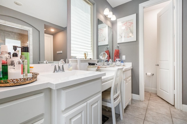 full bathroom featuring vanity, baseboards, and tile patterned flooring
