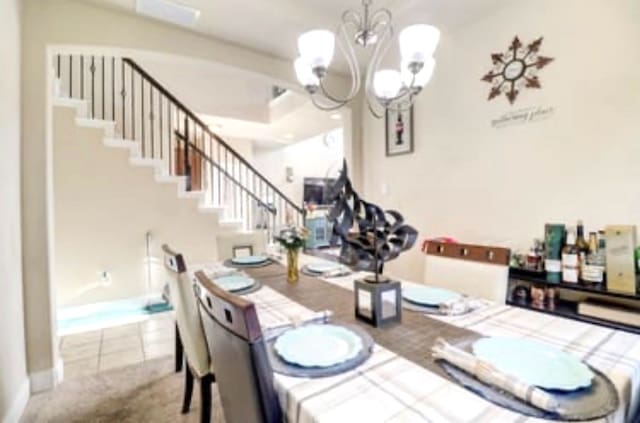 dining space featuring a notable chandelier, stairs, and tile patterned flooring