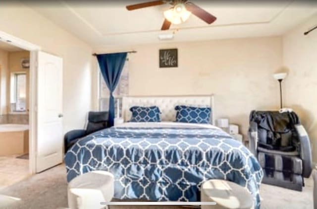 bedroom with connected bathroom and carpet floors