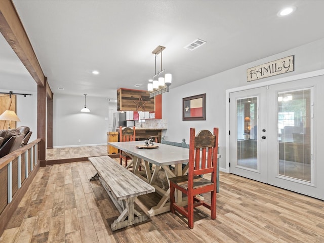 dining area featuring french doors, recessed lighting, light wood finished floors, and baseboards