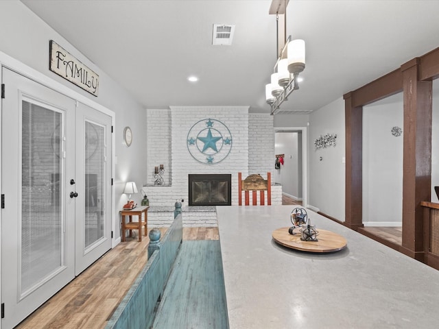 dining space with recessed lighting, visible vents, french doors, and a fireplace
