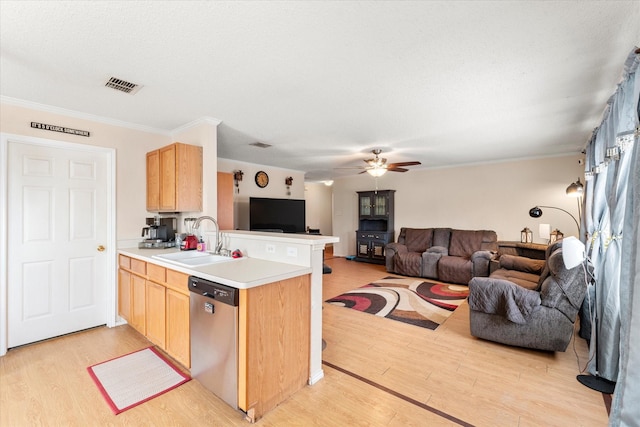 kitchen featuring dishwasher, visible vents, light brown cabinetry, and a sink