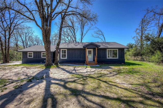 single story home with board and batten siding and a front lawn
