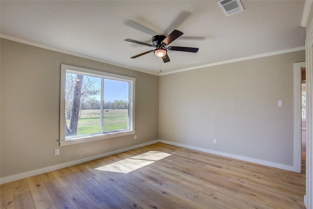 unfurnished room featuring visible vents, a ceiling fan, ornamental molding, wood-type flooring, and baseboards