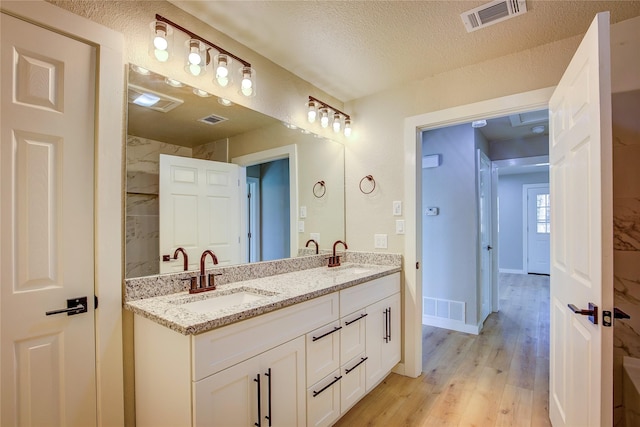 full bath featuring visible vents and a sink
