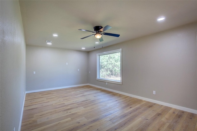 empty room featuring recessed lighting, light wood finished floors, a ceiling fan, and baseboards