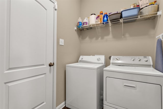 washroom featuring washer and clothes dryer and laundry area
