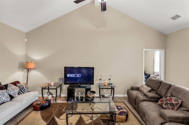living area featuring baseboards, carpet, visible vents, ceiling fan, and high vaulted ceiling
