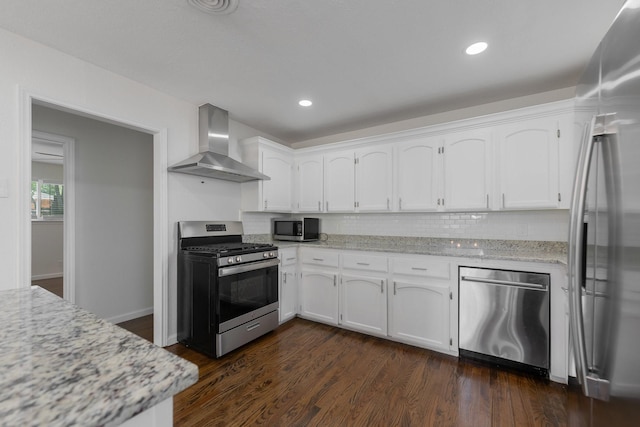 7024 Irongate Ln, Dallas, TX 75214 - kitchen with stainless steel appliances, wall chimney range hood, white cabinets, decorative backsplash, and dark wood finished floors
