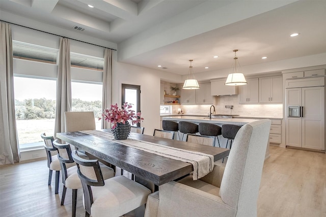 dining area with beamed ceiling, visible vents, light wood-type flooring, and recessed lighting