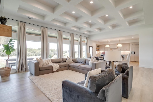 living room with recessed lighting, visible vents, light wood finished floors, and beamed ceiling
