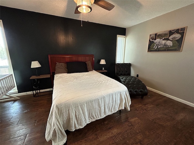 bedroom featuring baseboards, a ceiling fan, wood finished floors, and a textured ceiling