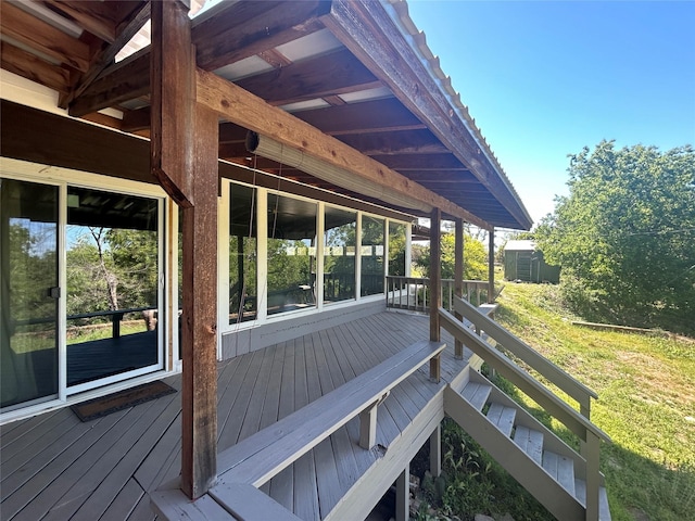 wooden deck with an outdoor structure and a shed