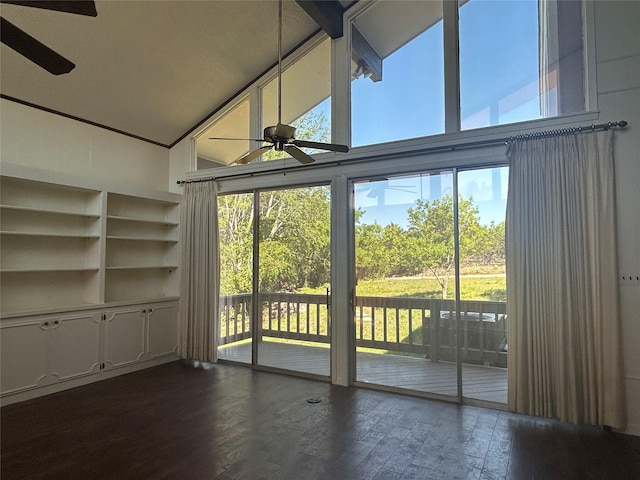 unfurnished living room featuring a ceiling fan, high vaulted ceiling, and dark wood-style floors