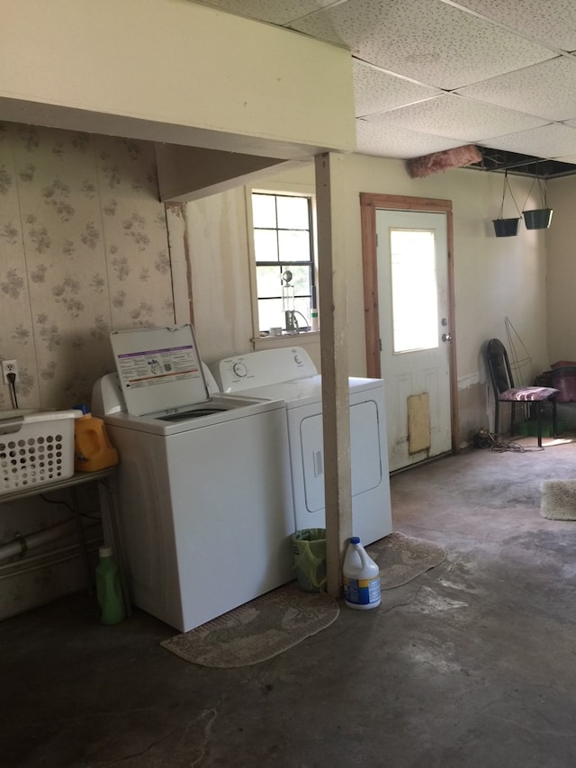 clothes washing area featuring laundry area and washer and clothes dryer