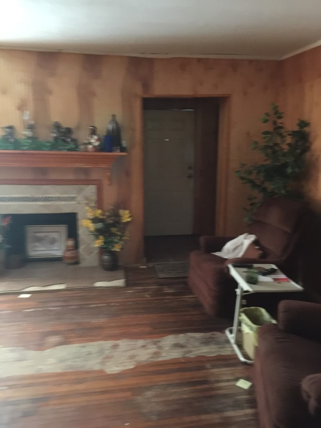 living room featuring a glass covered fireplace and wood finished floors