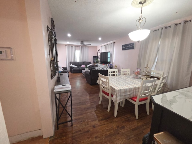 dining area with dark wood-style floors and recessed lighting