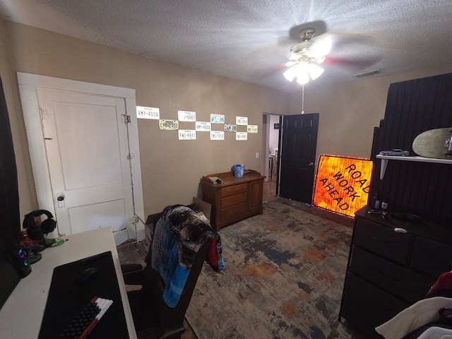 bedroom featuring visible vents, carpet floors, a textured ceiling, and ceiling fan