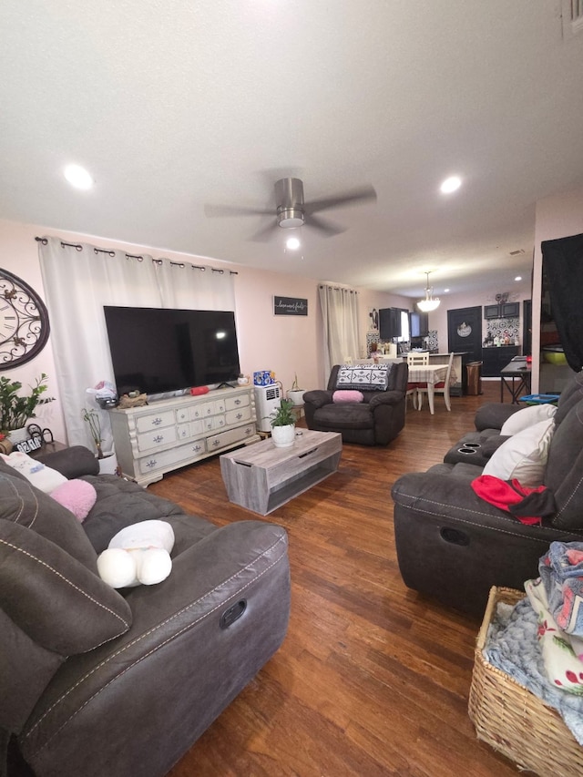 living room with recessed lighting, wood finished floors, visible vents, and ceiling fan with notable chandelier