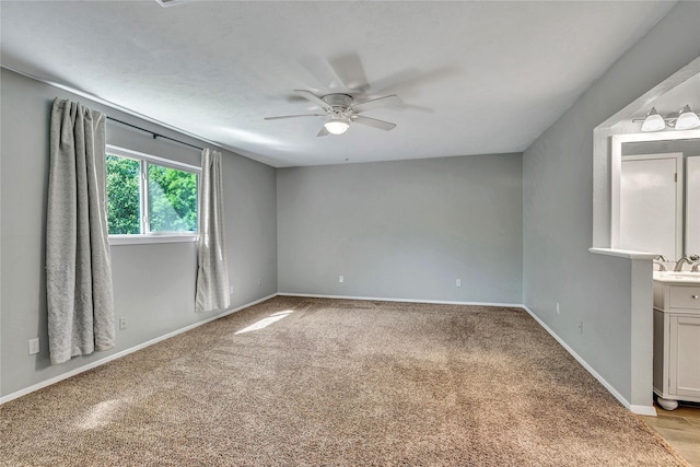 4225 Dawn Dr, Benbrook, TX 76116 - empty room with baseboards, light colored carpet, a sink, and ceiling fan