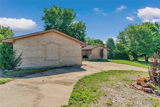 4225 Dawn Dr, Benbrook, TX 76116 - view of home's exterior featuring a lawn and brick siding
