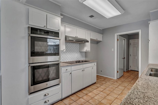 4225 Dawn Dr, Benbrook, TX 76116 - kitchen with decorative backsplash, stainless steel double oven, white cabinetry, black electric cooktop, and under cabinet range hood