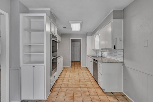 4225 Dawn Dr, Benbrook, TX 76116 - kitchen with a sink, built in features, white cabinets, backsplash, and appliances with stainless steel finishes