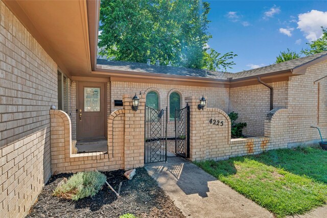 4225 Dawn Dr, Benbrook, TX 76116 - view of exterior entry with a gate and brick siding