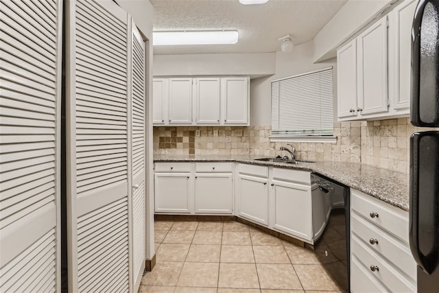 kitchen featuring decorative backsplash, a sink, light stone counters, black appliances, and white cabinetry