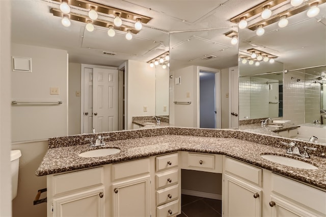 full bathroom featuring double vanity, a sink, and a shower stall