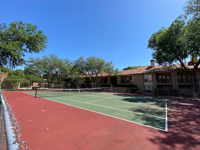 view of sport court featuring fence