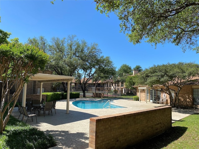 pool featuring fence and a patio area